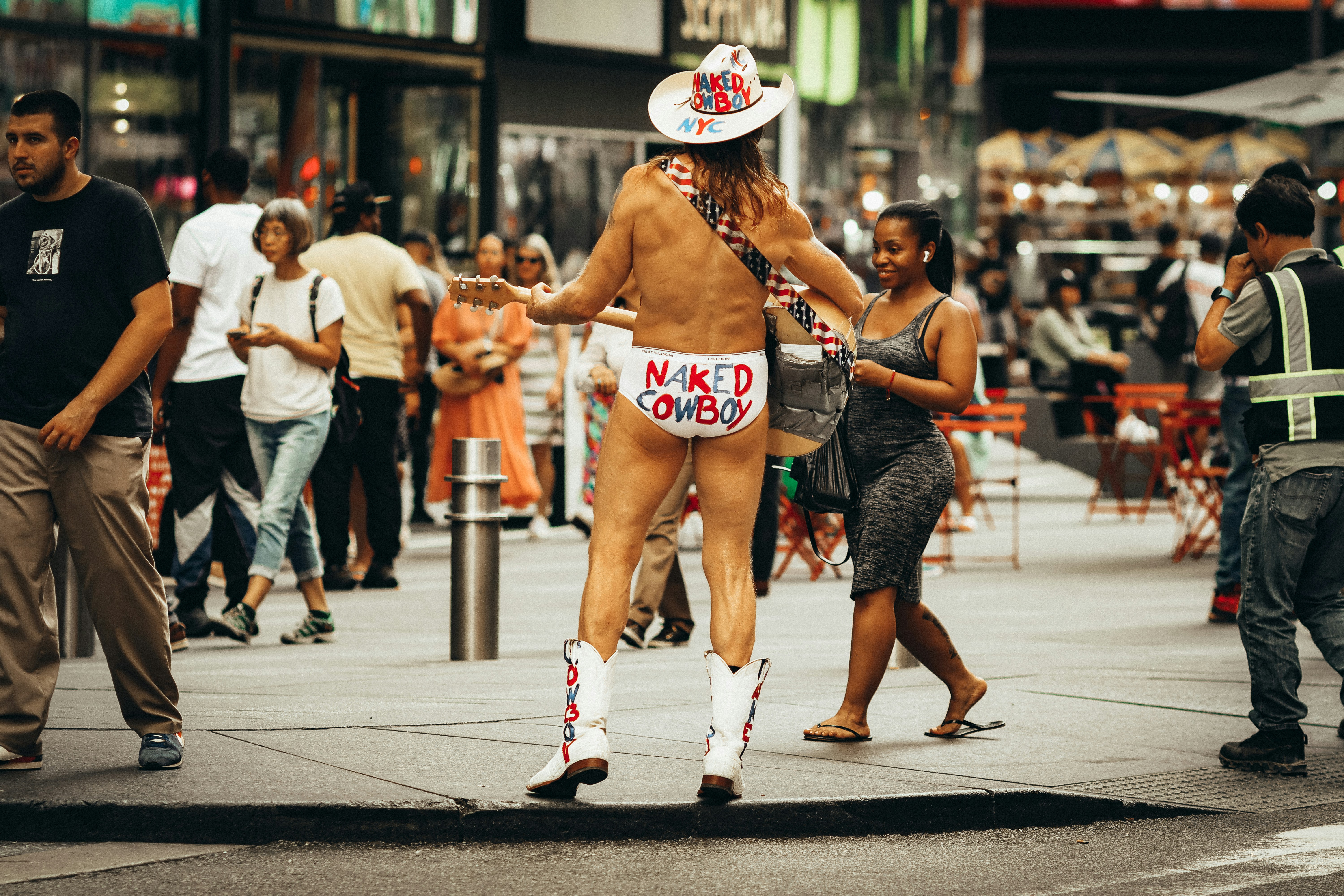 a naked man is walking down the street