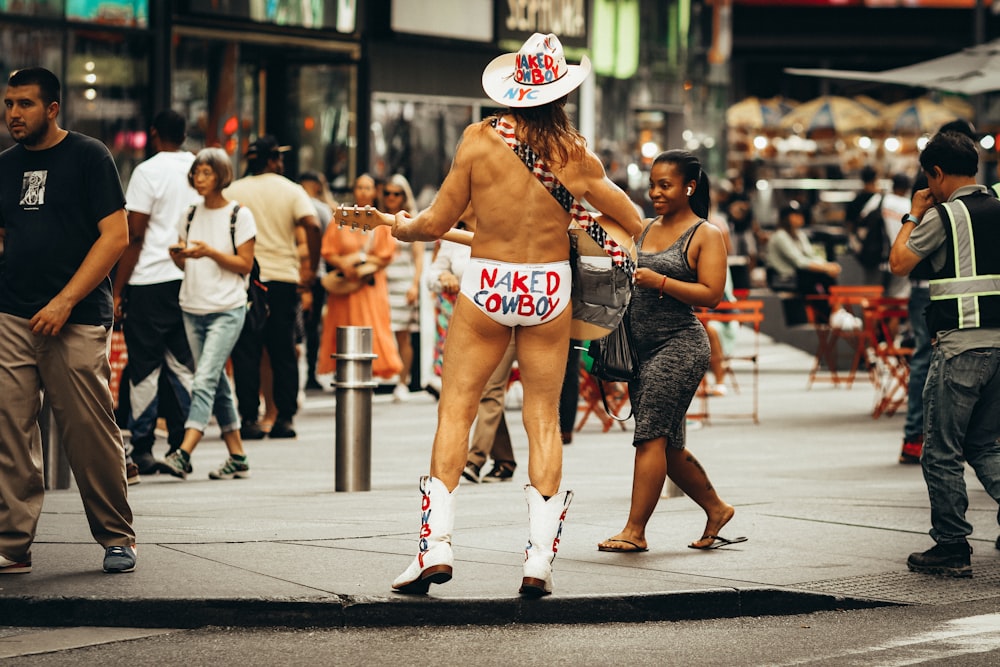 a naked man is walking down the street