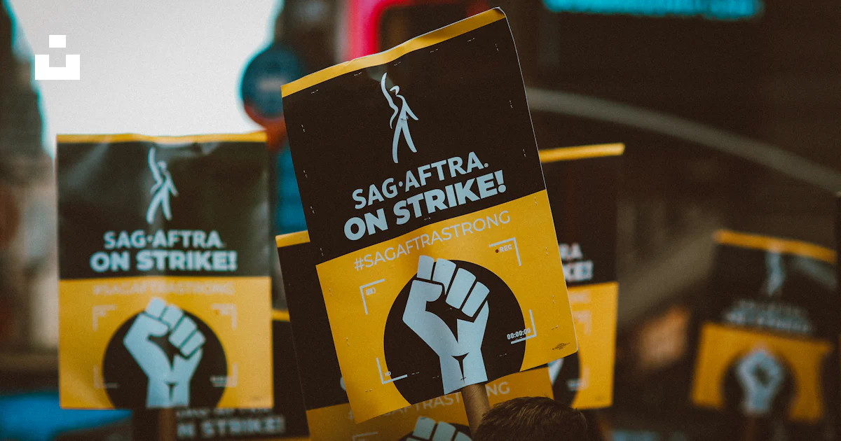 A group of people holding up protest signs photo – Free Union Image on ...