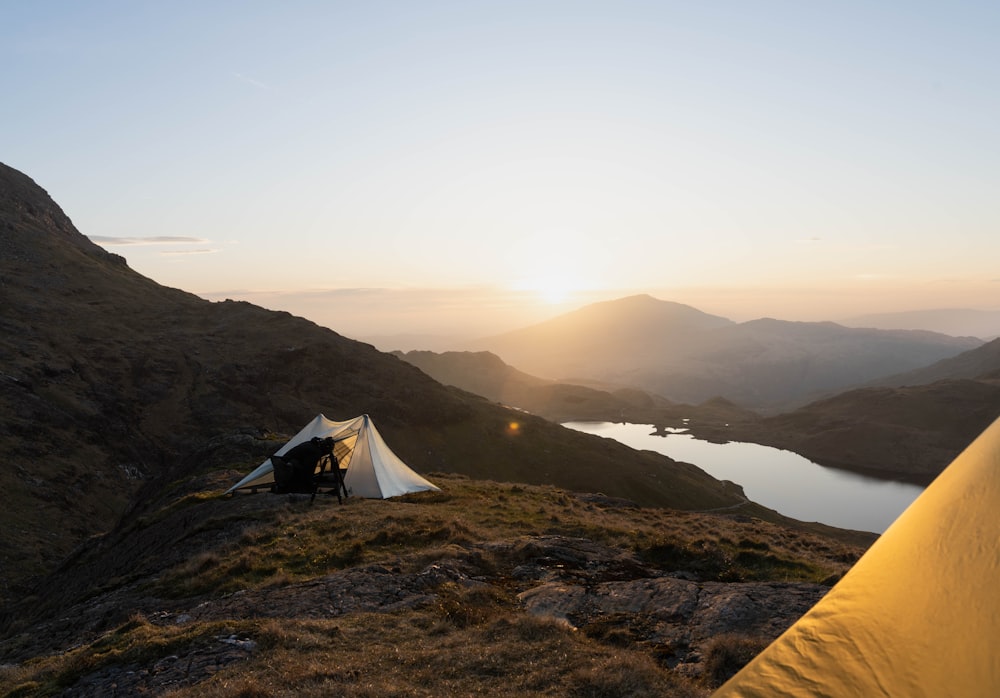 a couple of tents sitting on top of a mountain