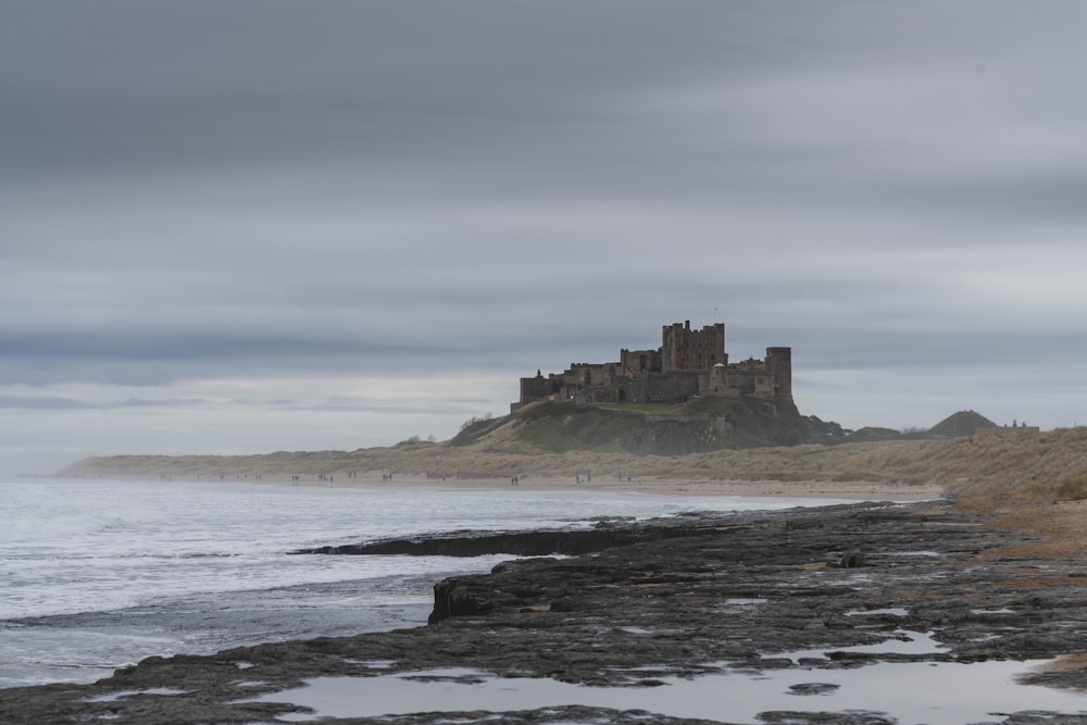 a castle sitting on top of a cliff next to the ocean