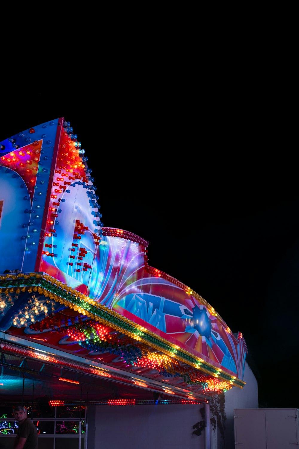 a brightly lit carnival ride at night time
