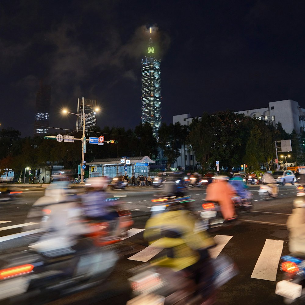 a group of people riding motorcycles down a street