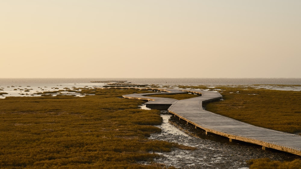 a wooden walkway leading to a body of water