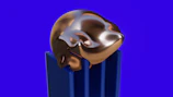 A close-up of a polished skeptron resting on a dark blue velvet cloth with gold trim.