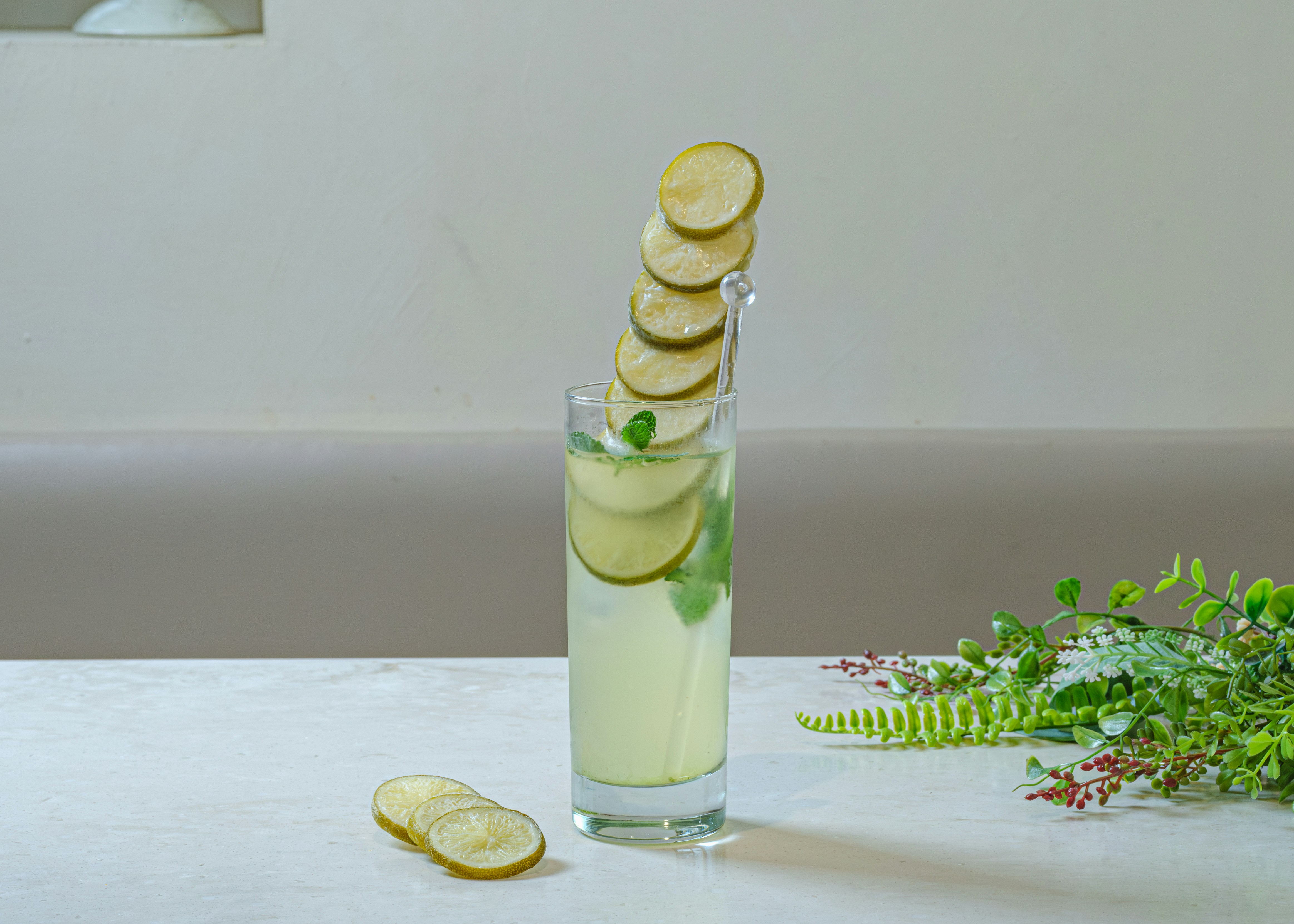 Glass of lemon-lime infused water with ice and mint on a table
