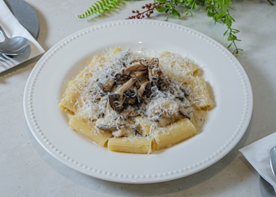 A rustic bowl of fettuccine tossed in a creamy mushroom sauce with parmesan.