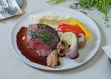A beautifully plated main course showcasing a juicy steak with seasonal vegetables.