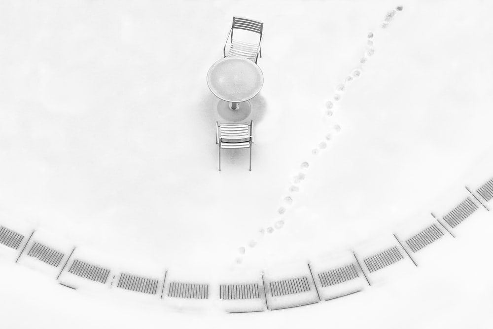 an aerial view of a table and chairs in the snow