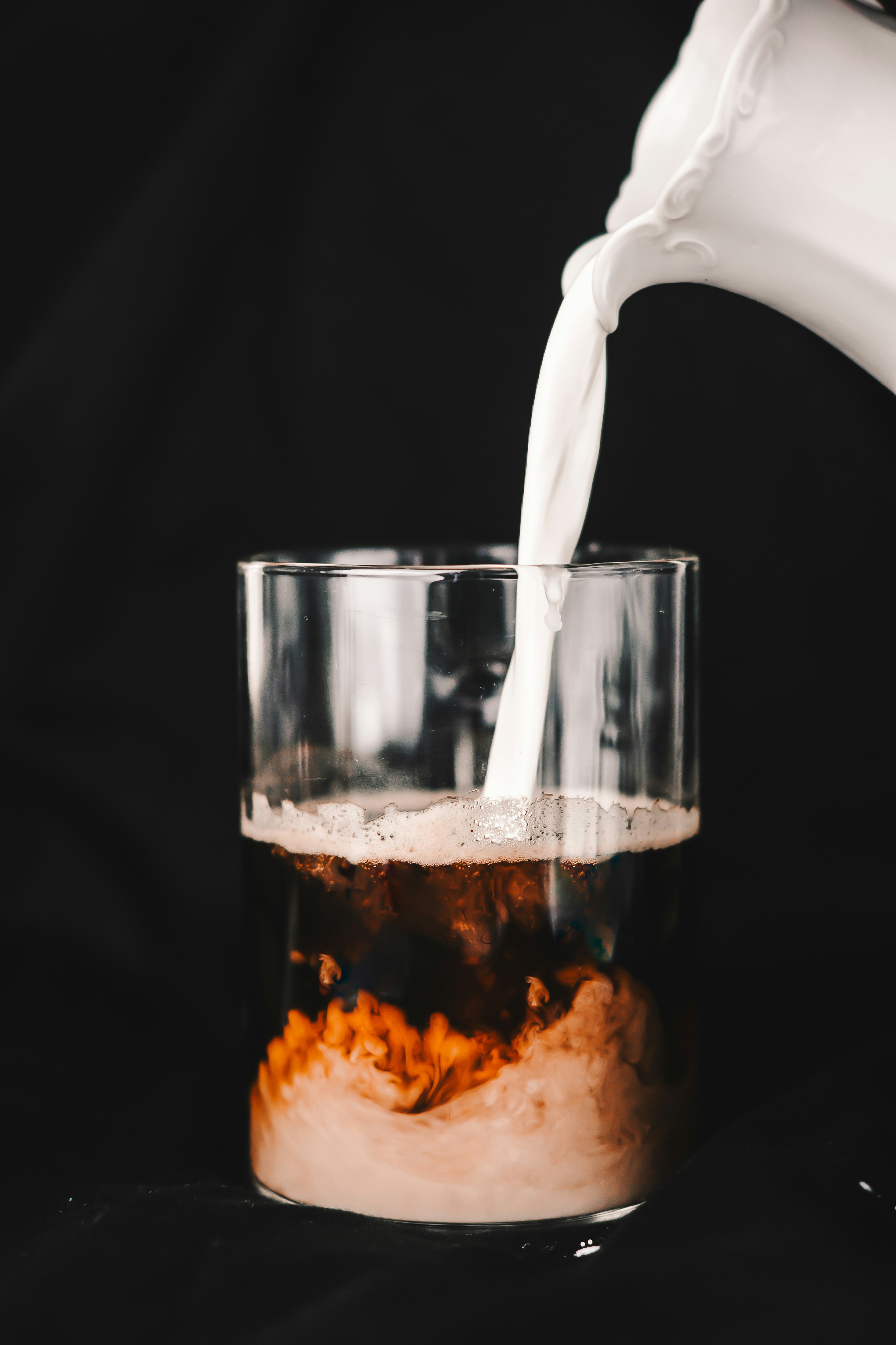 a glass of milk being poured into a glass