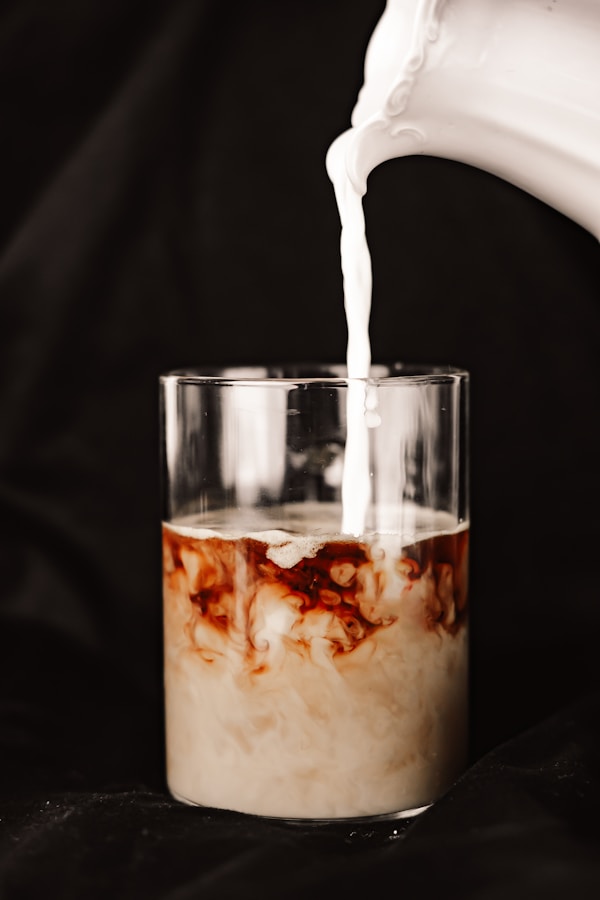 A glass of milk being poured into it