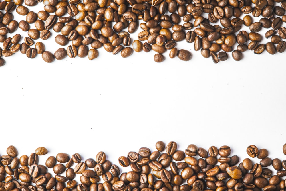 a pile of coffee beans on a white background