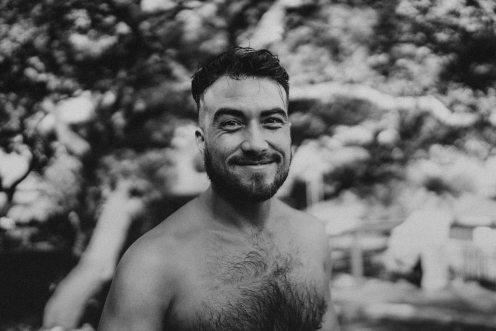a black and white photo of a shirtless man
