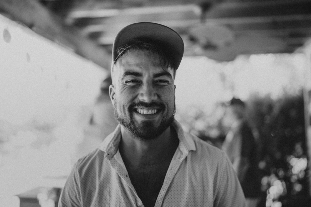 a black and white photo of a man smiling