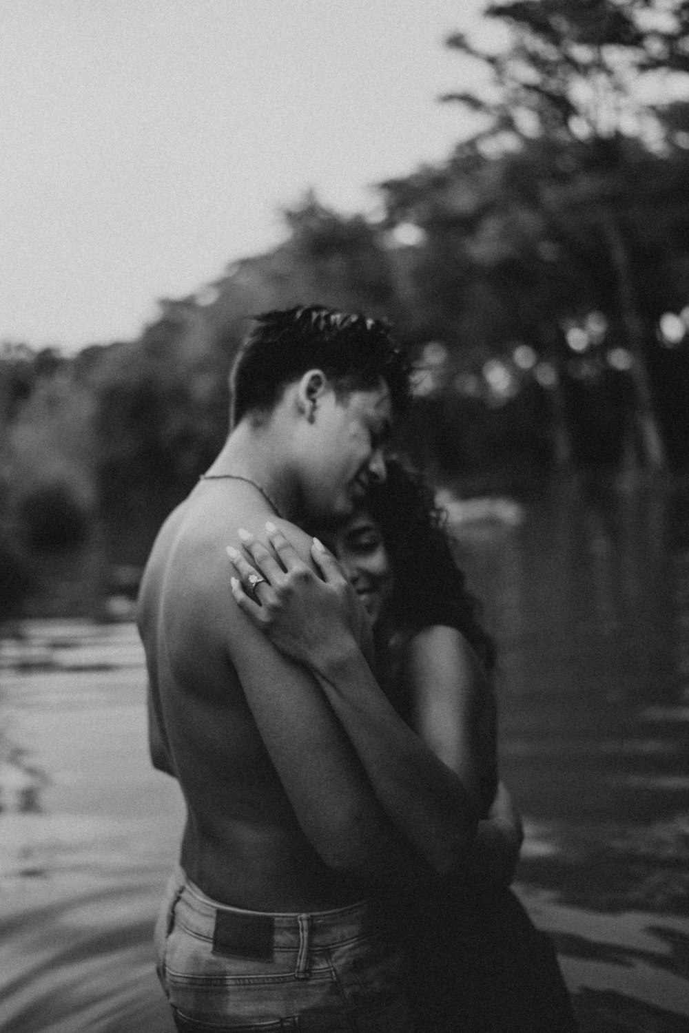 a man and a woman embracing in the water