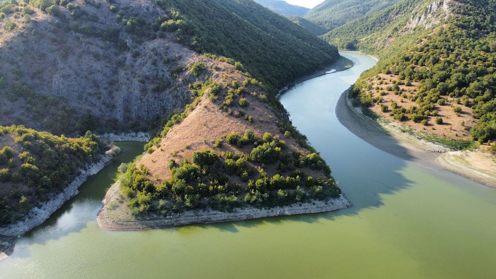 an aerial view of a river surrounded by mountains