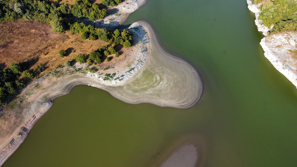 an aerial view of a body of water surrounded by trees