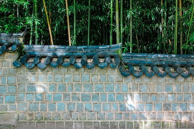 A curved privacy wall made of smooth stone veneer blending into a garden.