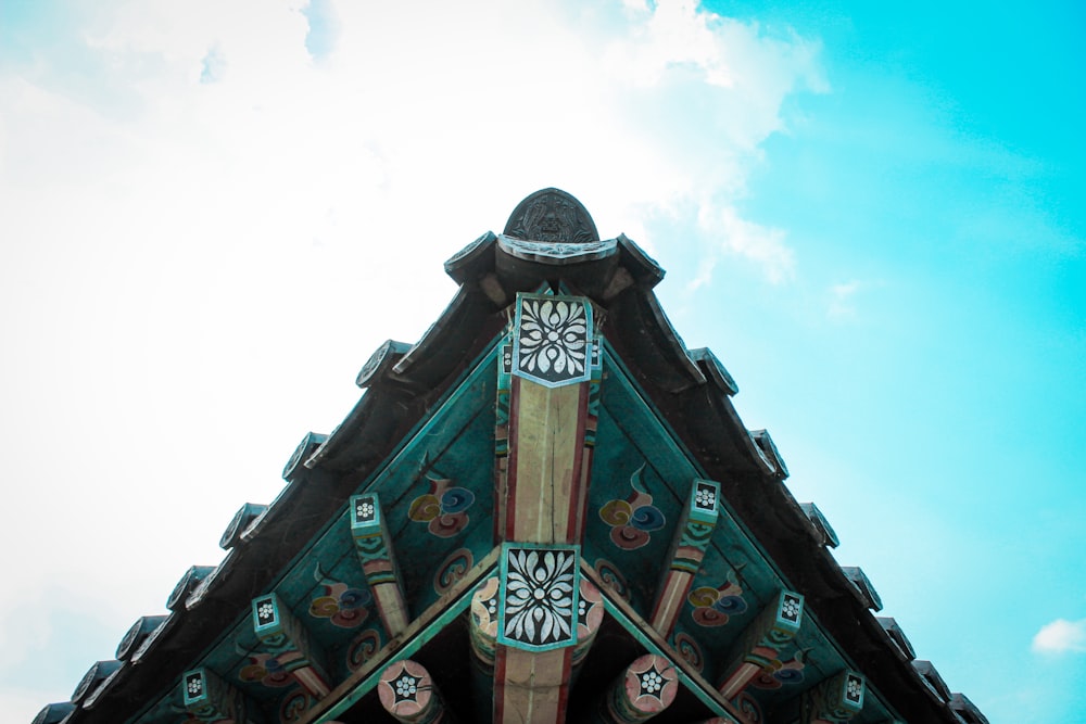 a clock on the side of a building with a sky background