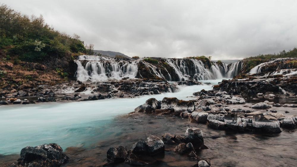 a river with a waterfall in the background