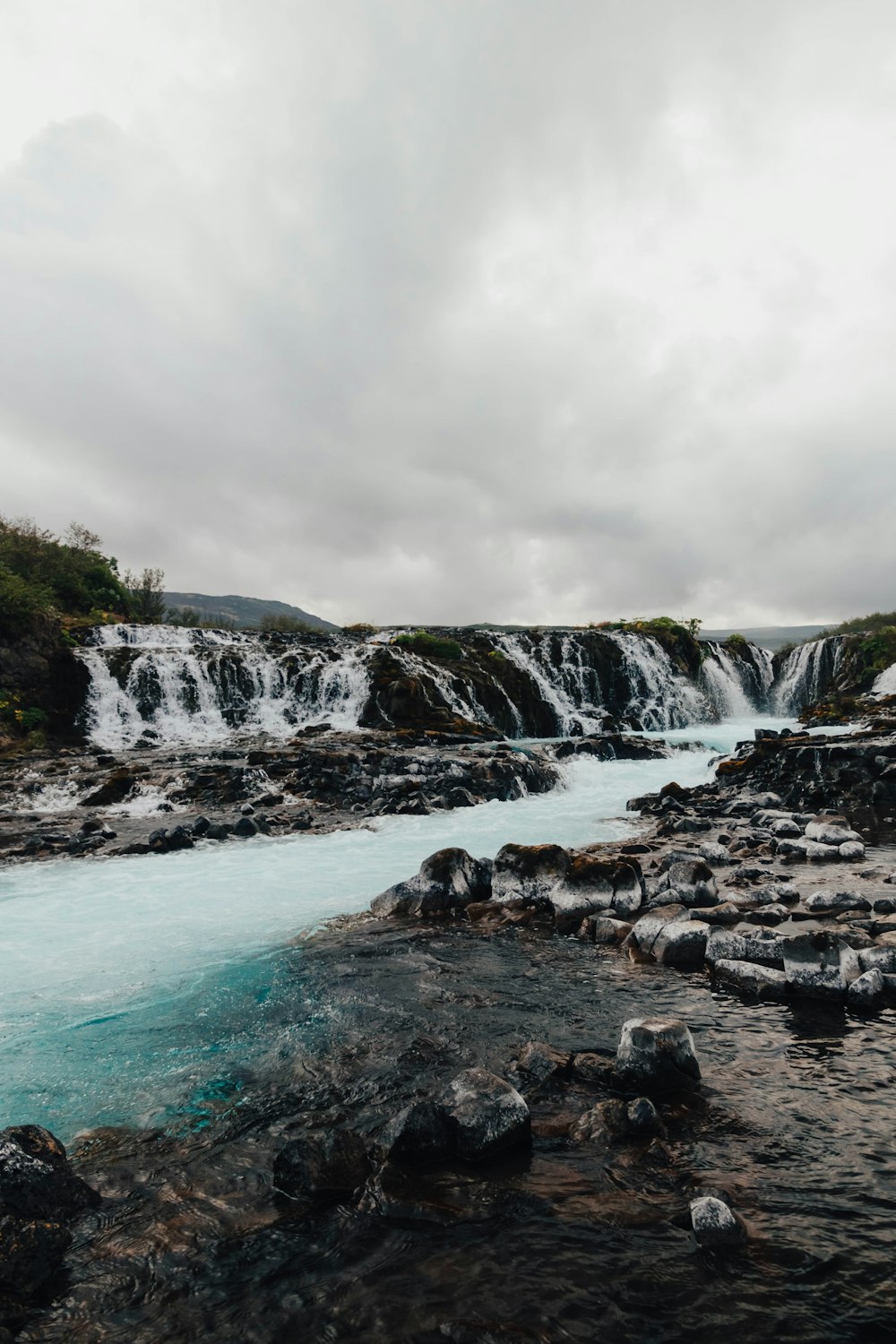 a river with a waterfall in the background