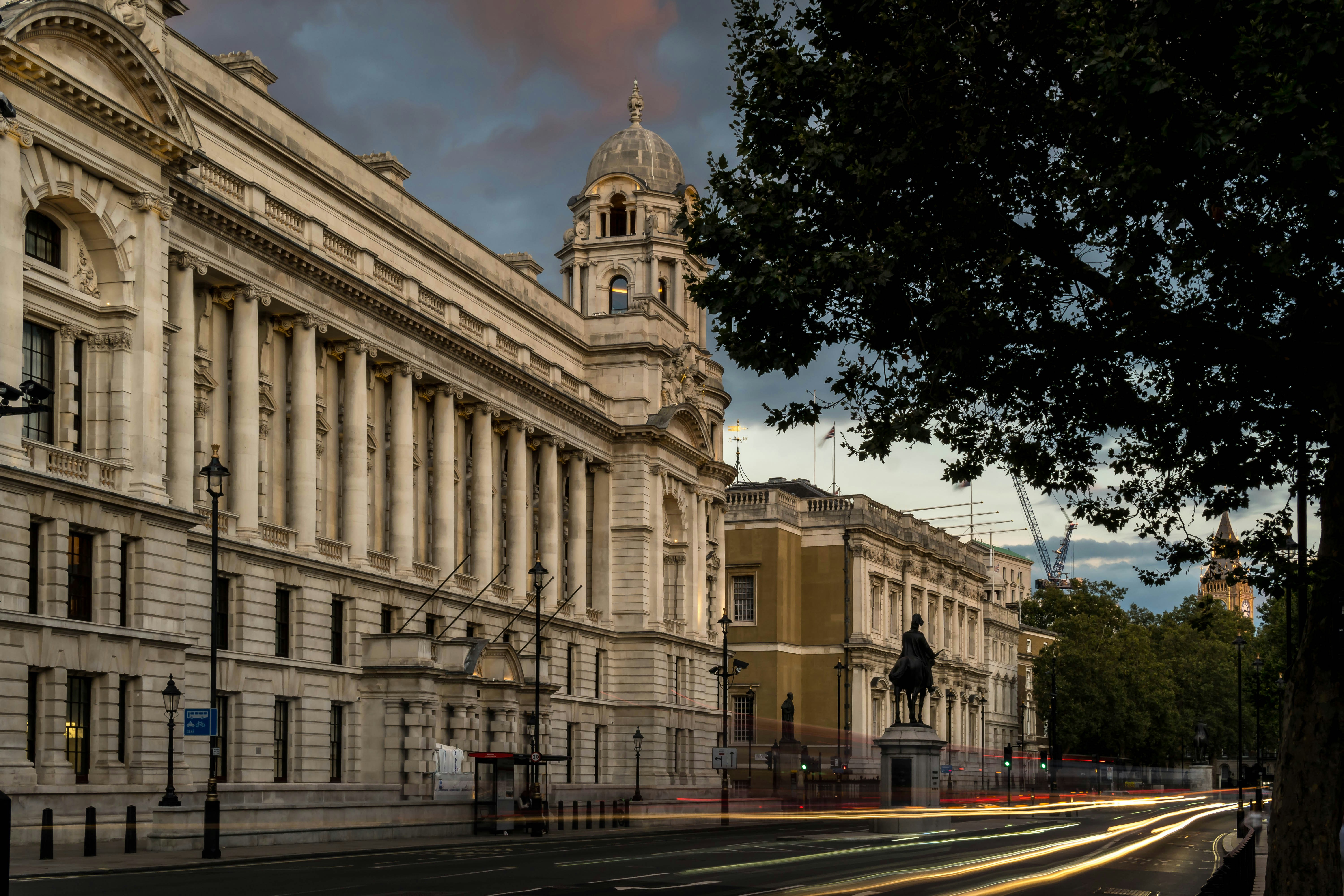 a large building with a clock tower next to a street