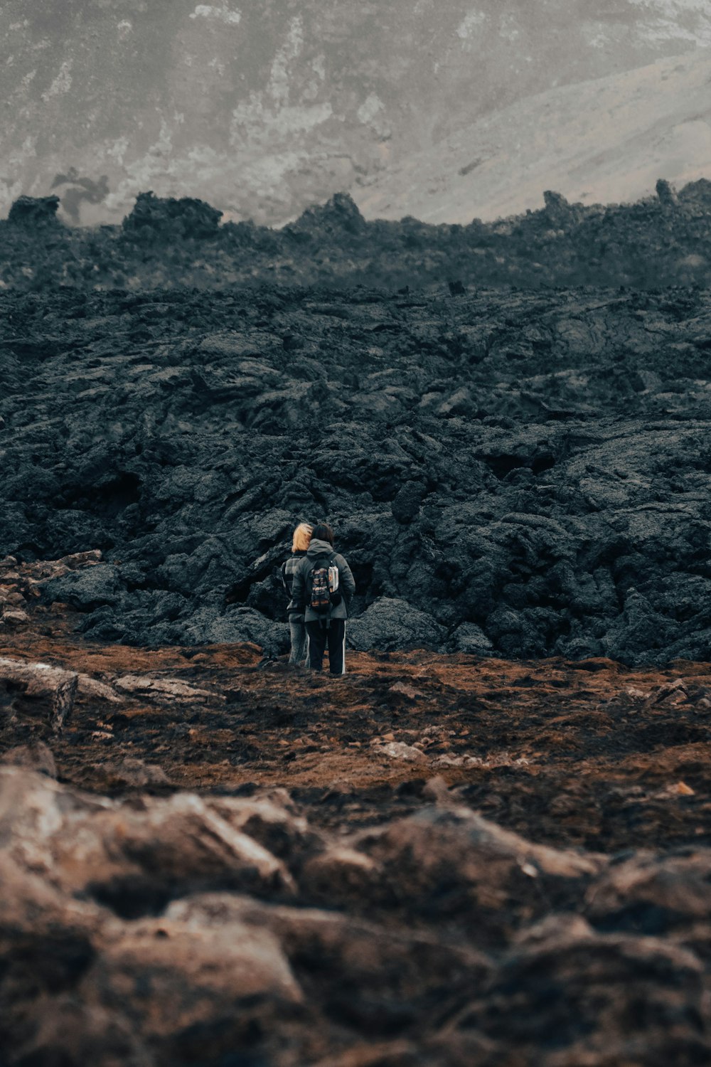 a man standing on top of a rocky hillside