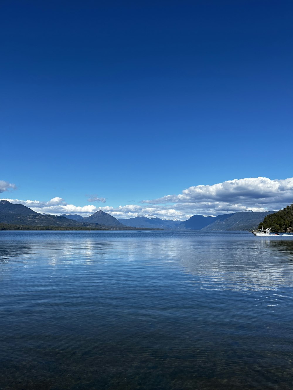 a body of water with mountains in the background