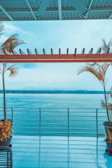 Balcony overlooking the turquoise water and bustling Saranda promenade.