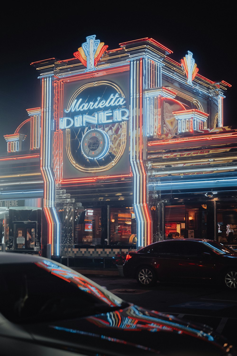 a large building with a neon sign on it's side