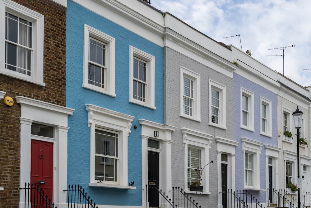 a row of multi - colored houses on a city street