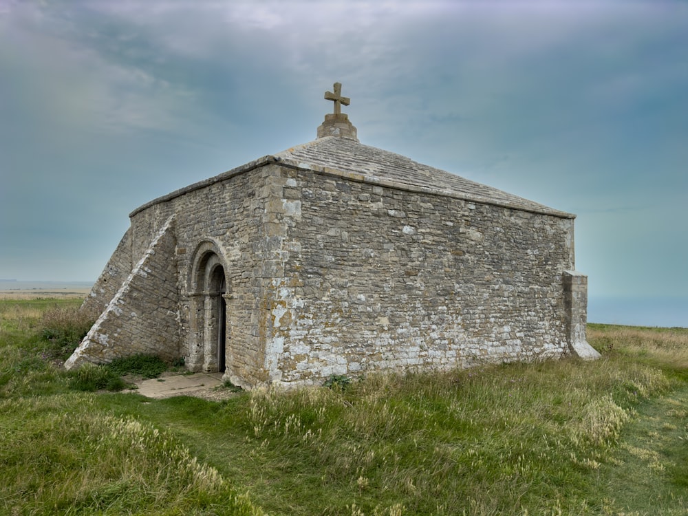 a stone building with a cross on top of it