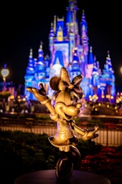 Close-up of Minnie and Mickey mascots waving happily to children.