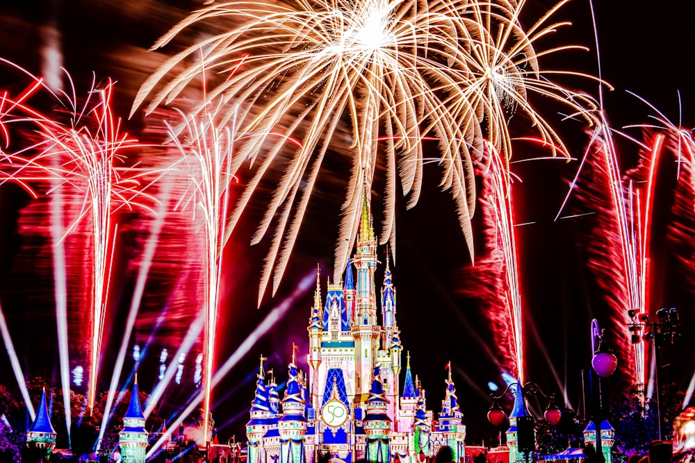 a fireworks display in front of a castle