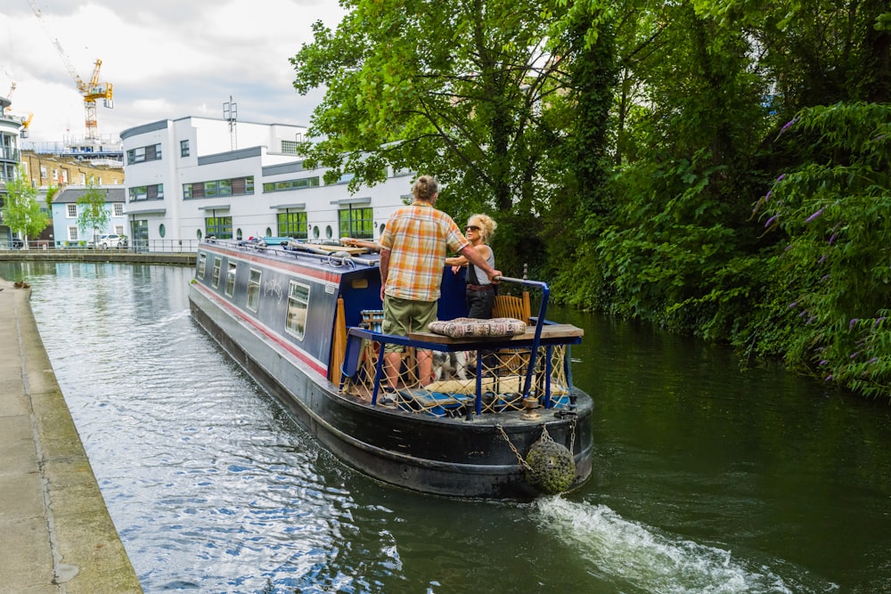 a couple of people riding on the back of a boat