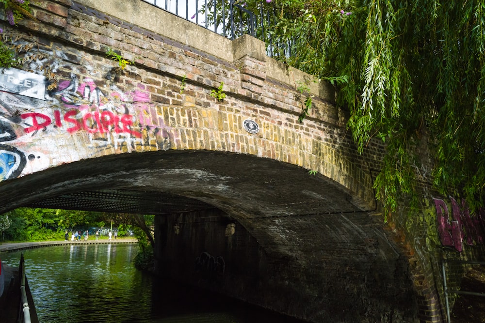 a bridge that has graffiti on it