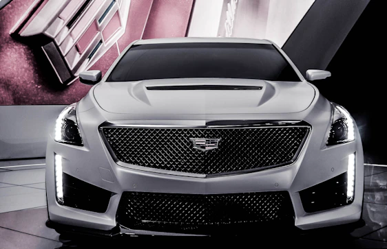 A sleek black luxury car silhouette merging with a digital network grid, symbolizing high-end automotive connections.