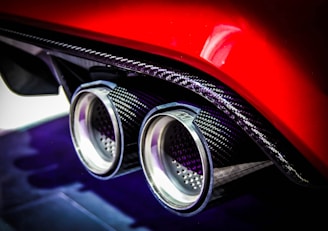 Close-up of a shiny custom exhaust system installed on a car.
