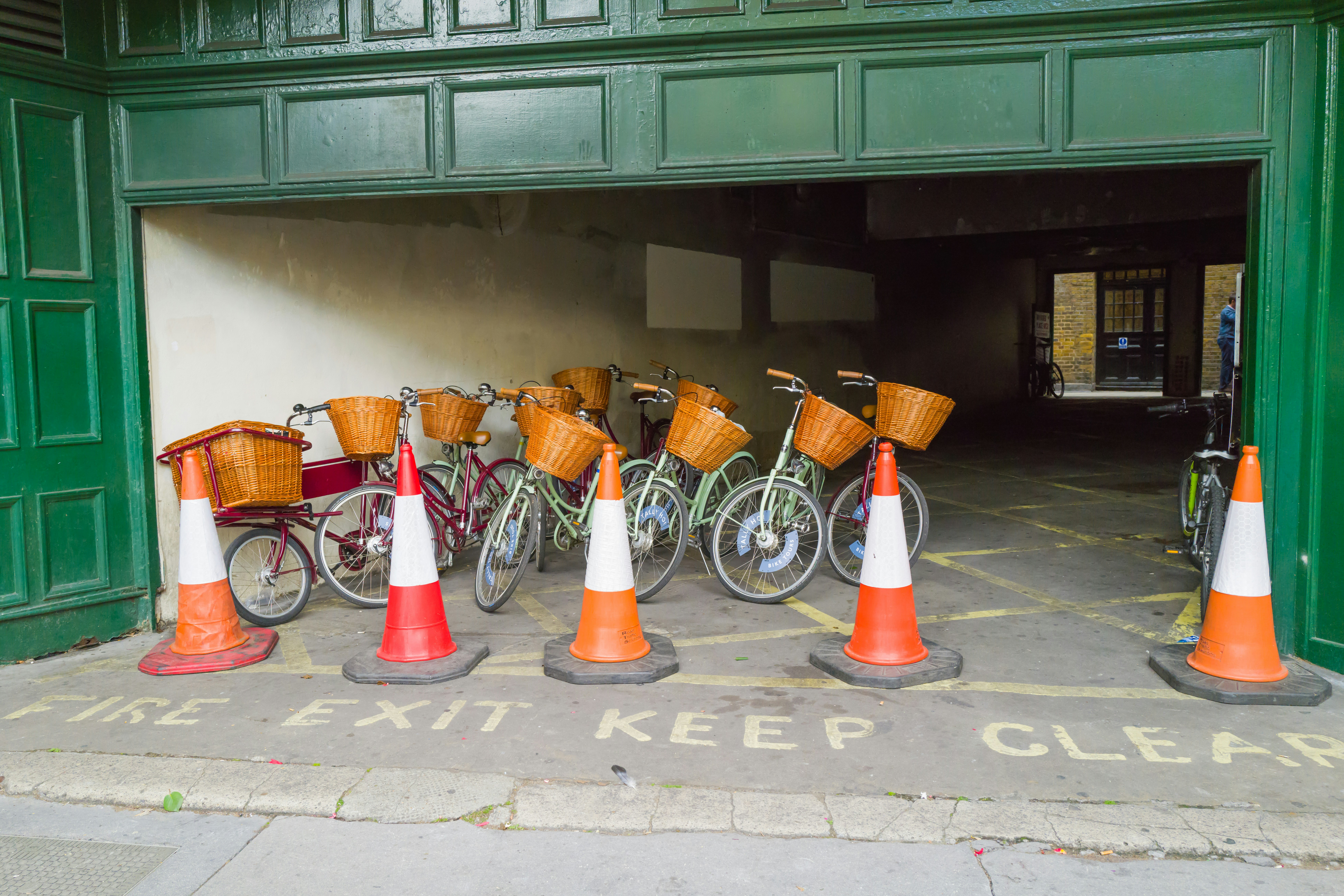 a group of bicycles parked next to orange and white cones