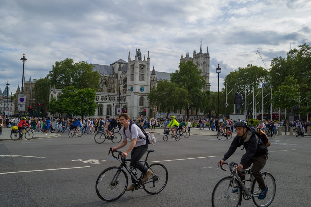 a group of people riding bikes down a street