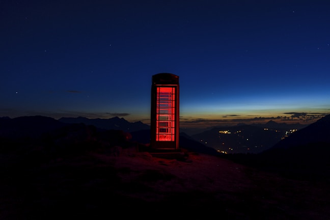 Sunset over the Riverside skyline with a silhouette of a red British telephone booth.