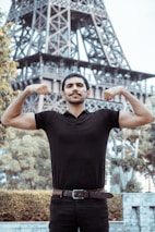 A man outdoors, standing tall with a strong, confident posture symbolizing personal growth.