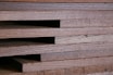 Close-up of sturdy wooden planks stacked neatly at a construction site.