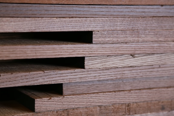 Close-up of natural wood textures stacked in an organized workshop setting