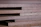 Close-up of stacked tropical timber planks with rich natural grain patterns.