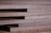 A close-up of wooden planks stacked neatly in a warehouse.