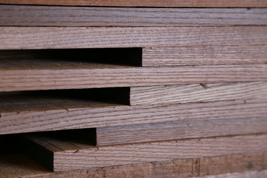 A close-up of wooden planks stacked neatly in a warehouse.