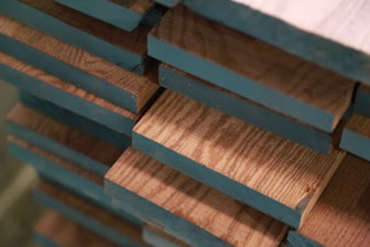 A close-up of wooden planks stacked neatly in a warehouse.