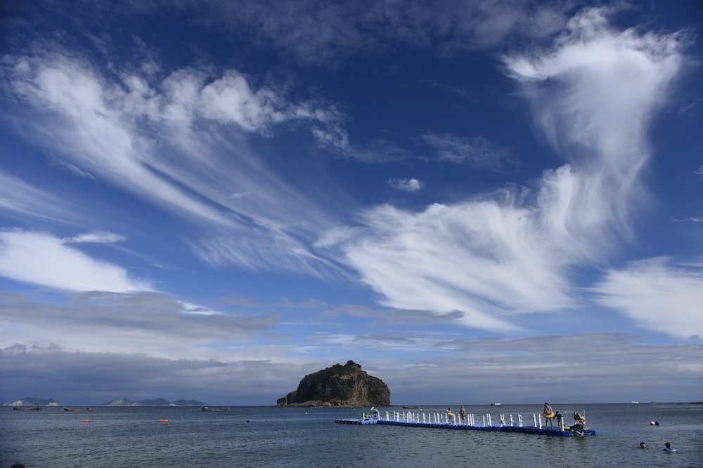 a large body of water with a small island in the background