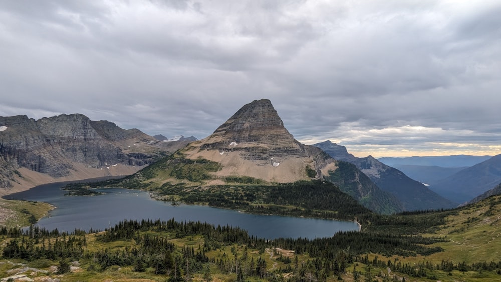 a mountain range with a lake in the foreground